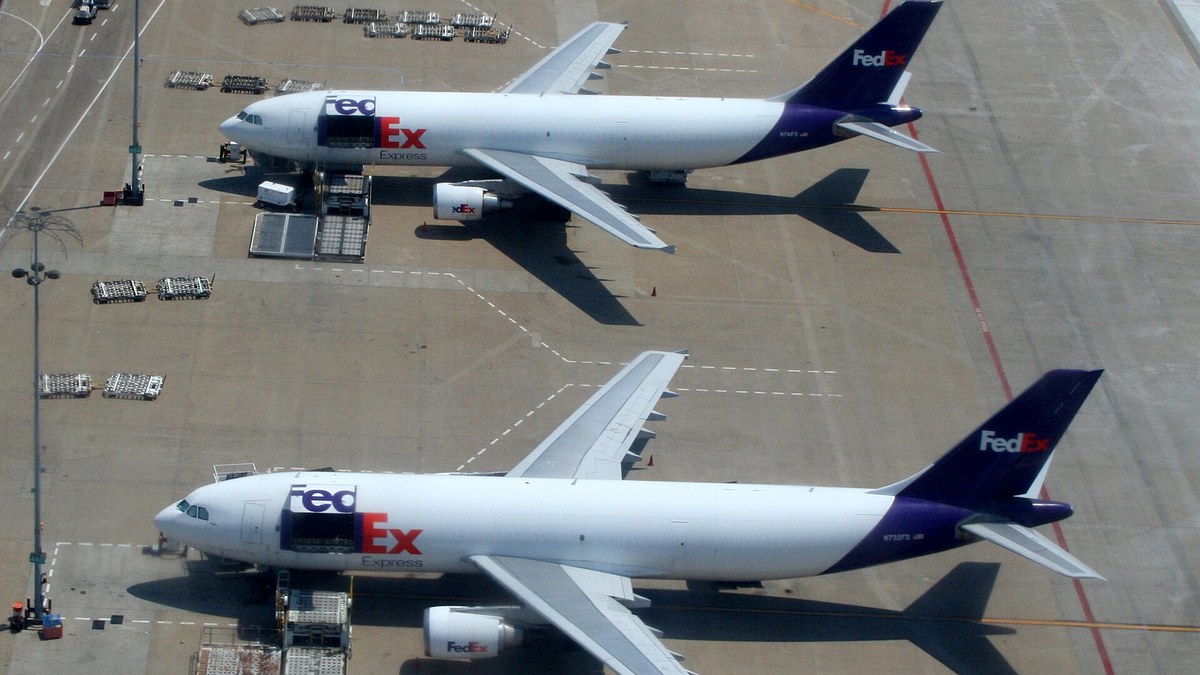 civilian cargo aircraft being loaded at an airport